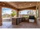 The outdoor kitchen and bar area is perfect for hosting outdoor entertaining at 23126 N 45Th Pl, Phoenix, AZ 85050
