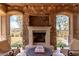 Covered patio with an outdoor fireplace offers a cozy outdoor seating area at 23126 N 45Th Pl, Phoenix, AZ 85050