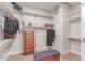 Walk-in closet featuring multiple shelves and drawers, plus a padded bench for storage at 23126 N 45Th Pl, Phoenix, AZ 85050