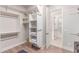 Well-organized walk-in closet with open shelving and an access door to the bedroom at 23126 N 45Th Pl, Phoenix, AZ 85050