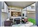 Beautiful outdoor seating area under a covered patio, offering a view of the home's open-concept kitchen and living space at 25326 N 19Th Dr, Phoenix, AZ 85085