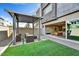 Charming backyard with a covered pergola over a seating area that seamlessly transitions into the home's living space at 25326 N 19Th Dr, Phoenix, AZ 85085