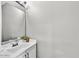 Stylish powder room featuring a sleek vanity, modern faucet, and a tastefully decorated space at 25326 N 19Th Dr, Phoenix, AZ 85085