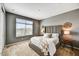 Spacious bedroom with a large window, plush carpeting, and a contemporary design for relaxing ambiance at 25326 N 19Th Dr, Phoenix, AZ 85085