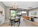 Dining area with an open floor plan that flows into a well lit living room, with access to the covered patio at 25326 N 19Th Dr, Phoenix, AZ 85085