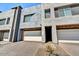 Contemporary townhome showcasing modern architecture, a private two-car garage, and well-maintained landscaping at 25326 N 19Th Dr, Phoenix, AZ 85085
