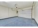 Clean and spacious garage featuring a pristine epoxy floor and a modern white garage door at 25326 N 19Th Dr, Phoenix, AZ 85085