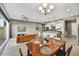 Bright open-concept living space features modern fixtures and a seamless flow into the dining and kitchen areas at 25326 N 19Th Dr, Phoenix, AZ 85085