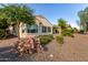 Home's backyard with rock landscaping, desert plants, and covered patio at 27105 W Marco Polo Rd, Buckeye, AZ 85396