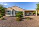 Home's backyard with rock landscaping, a covered patio, and desert plants at 27105 W Marco Polo Rd, Buckeye, AZ 85396