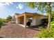 Home's backyard with rock landscaping, covered patio, and desert plants at 27105 W Marco Polo Rd, Buckeye, AZ 85396