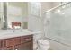 Bathroom sink, vanity, and toilet enclosed by a glass shower door at 27105 W Marco Polo Rd, Buckeye, AZ 85396