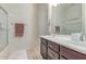 Bathroom featuring double sink vanity, a towel rack, and a shower with glass door at 27105 W Marco Polo Rd, Buckeye, AZ 85396