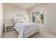 Bright bedroom with a queen bed, white linens, a side table, and a window at 27105 W Marco Polo Rd, Buckeye, AZ 85396