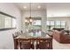 Formal dining area with stylish chandelier and views of the well-maintained lawn at 27105 W Marco Polo Rd, Buckeye, AZ 85396