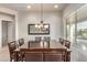 Spacious dining area featuring a long table, seating for eight and modern lighting fixtures at 27105 W Marco Polo Rd, Buckeye, AZ 85396