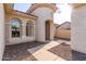 Inviting front entrance with rounded features, tiled walkway, and landscaped bed at 27105 W Marco Polo Rd, Buckeye, AZ 85396