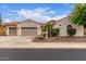 Charming single-story home with a three-car garage, desert landscaping, and a red tile roof at 27105 W Marco Polo Rd, Buckeye, AZ 85396