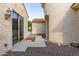 Side yard with block wall, sliding glass door, and access to the front entrance walkway at 27105 W Marco Polo Rd, Buckeye, AZ 85396