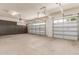 Spacious garage with two car access doors, gray cabinets, and concrete floor at 27105 W Marco Polo Rd, Buckeye, AZ 85396