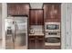 Kitchen close-up showing stainless steel refrigerator, oven, microwave, and granite countertops at 27105 W Marco Polo Rd, Buckeye, AZ 85396
