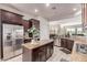 Bright kitchen featuring granite countertops, stainless steel appliances, and dark wood cabinetry at 27105 W Marco Polo Rd, Buckeye, AZ 85396