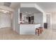 Kitchen bar with granite countertops and seating, leading to a view of the gourmet kitchen at 27105 W Marco Polo Rd, Buckeye, AZ 85396