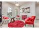 Inviting living room with decorative rug, chairs, and a side table with bright lighting at 27105 W Marco Polo Rd, Buckeye, AZ 85396