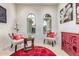 Bright and airy living room with a decorative rug and arched windows offering plenty of natural light at 27105 W Marco Polo Rd, Buckeye, AZ 85396