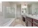 Luxurious main bathroom featuring a soaking tub, walk-in shower, and dual vanities at 27105 W Marco Polo Rd, Buckeye, AZ 85396
