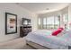 Serene main bedroom with a large window, stylish dresser, and relaxing ambiance at 27105 W Marco Polo Rd, Buckeye, AZ 85396
