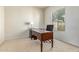 Office space featuring a dark wood desk, a chair, and a window at 27105 W Marco Polo Rd, Buckeye, AZ 85396