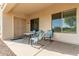 Covered patio area with a table and four upholstered chairs at 27105 W Marco Polo Rd, Buckeye, AZ 85396
