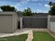 Backyard featuring artificial grass, a stone walkway, and a storage shed at 3021 E Shangri La Rd, Phoenix, AZ 85028