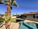 Inviting backyard with a large pool, tropical landscaping, and a well-manicured lawn at 3021 E Shangri La Rd, Phoenix, AZ 85028