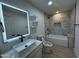 Modern bathroom featuring a vessel sink, illuminated mirror, and a luxurious tiled shower and tub combo at 3021 E Shangri La Rd, Phoenix, AZ 85028