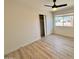 Cozy bedroom featuring sleek flooring, a ceiling fan, and a well-sized window at 3021 E Shangri La Rd, Phoenix, AZ 85028