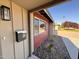 Close up of a front door with red siding and decorative rock landscaping at 3021 E Shangri La Rd, Phoenix, AZ 85028