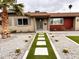 Attractive home with desert landscaping featuring a green astro-turf pathway and cacti at 3021 E Shangri La Rd, Phoenix, AZ 85028