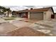 Charming single-story home featuring desert landscaping, a palm tree and a two car garage at 3021 E Shangri La Rd, Phoenix, AZ 85028