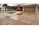 Charming single-story home featuring desert landscaping, a palm tree and a two car garage at 3021 E Shangri La Rd, Phoenix, AZ 85028