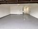Spacious garage with sealed concrete floor, bright lighting, and doors at 3021 E Shangri La Rd, Phoenix, AZ 85028