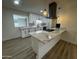 Kitchen island with white marble countertop and modern pendant lighting at 3021 E Shangri La Rd, Phoenix, AZ 85028