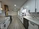 Kitchen featuring modern appliances, white cabinets, and stylish backsplash at 3021 E Shangri La Rd, Phoenix, AZ 85028
