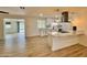 Open concept kitchen with white cabinets, quartz countertops and pendant lighting at 3021 E Shangri La Rd, Phoenix, AZ 85028