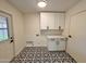 Laundry room features cabinets and graphic-patterned flooring at 3021 E Shangri La Rd, Phoenix, AZ 85028