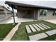 Covered patio featuring a tile floor, artificial grass, and concrete pavers at 3021 E Shangri La Rd, Phoenix, AZ 85028