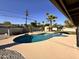 Inviting backyard with a pebble tec pool, lush tropical landscaping, and a spacious patio area at 3021 E Shangri La Rd, Phoenix, AZ 85028