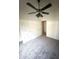 Cozy bedroom showcasing neutral carpet, a ceiling fan, and an open doorway at 3057 E Pinto Valley Rd, San Tan Valley, AZ 85143