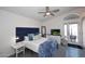 Stylish bedroom featuring a blue upholstered headboard, TV, and access to an outdoor patio at 3122 E Kristal Way, Phoenix, AZ 85050